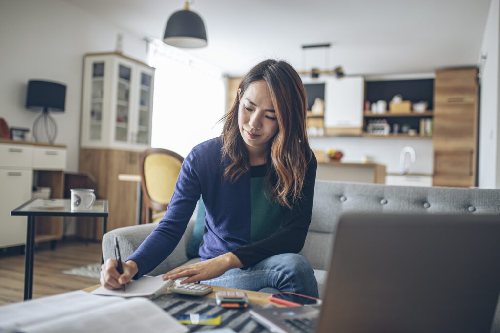 Young woman working on LinkedIn and budgeting.