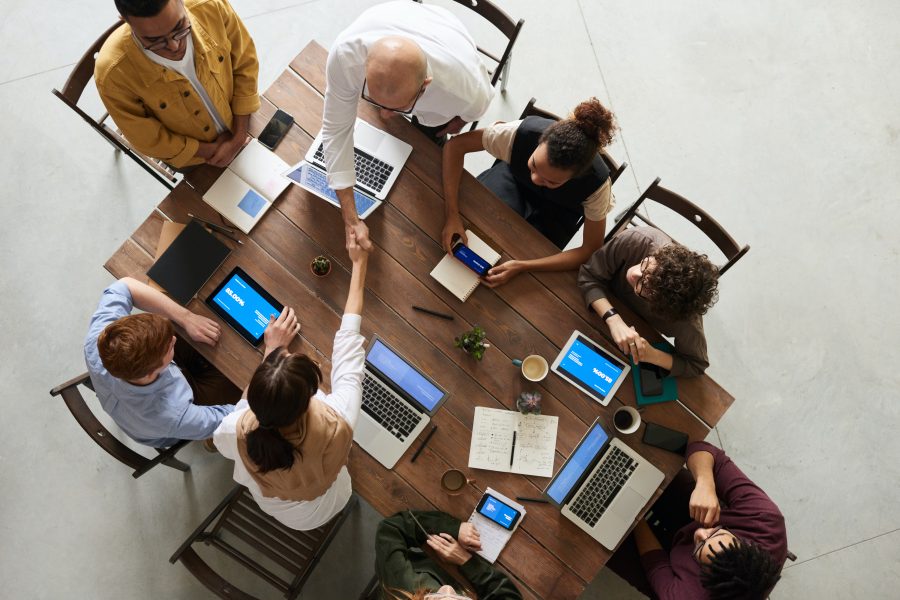 Group of business team mates at a desk, working together on their LinkedIn Ads